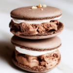 Stack of cool, creamy, chewy, crunchy rocky road chocolate macaron ice cream sandwiches.