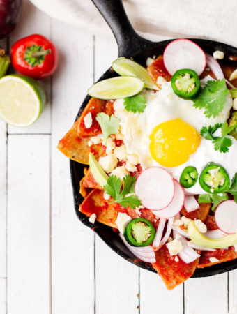 Easy Skillet Chilaquiles turn pantry staples like stale tortillas and canned tomatoes into a filling, fresh, and vibrant breakfast for one or for a crowd! How to make Easy Chilaquiles recipe with tomato sauce baked eggs | how to pronounce | rojos verdes breakfast gluten free vegetarian